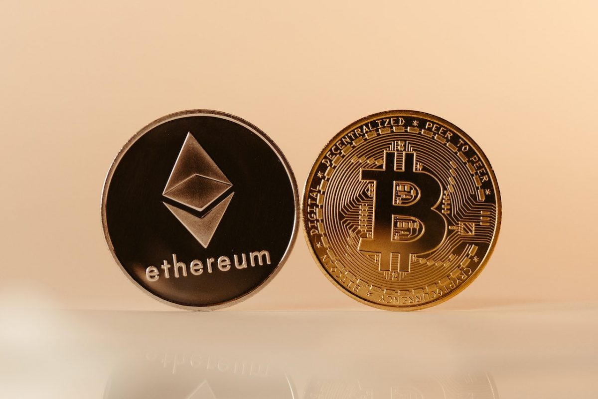 An illustration of a person holding a phone displaying a cryptocurrency chart with a regulatory flag in the background.